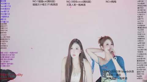 Video of two Asian women, one with long brown hair, the other with a bun, wearing casual clothes, sitting in front of a computer screen displaying text and chat logs.