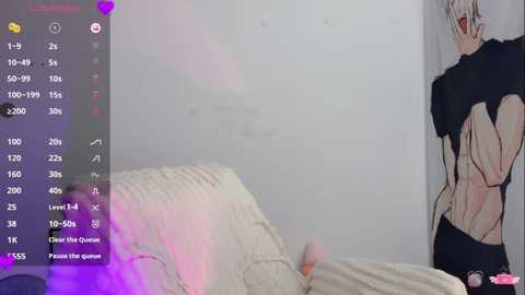 Video of a white-haired man in a black shirt and shorts, partially obscured by a white quilted blanket in a dimly lit bedroom, with a digital camera interface overlay.