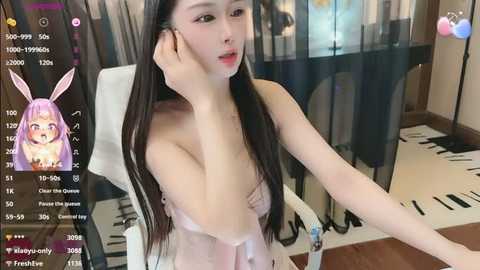 A video of a fair-skinned, slender East Asian woman with long, straight black hair and bunny ears, posing topless in a modern room.