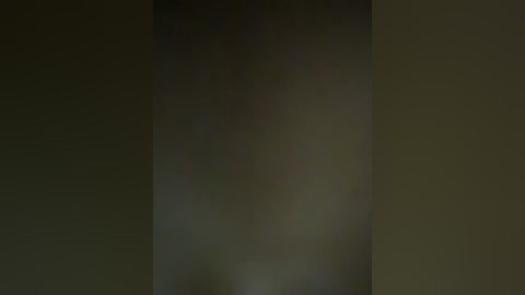 A dimly lit, blurry video with indistinct figures and muted colors, possibly depicting a nighttime scene with indeterminate objects or people in the background.