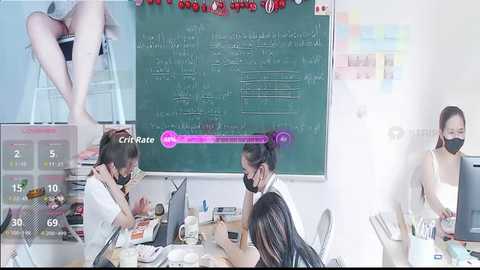 Video of three Asian women in a classroom with a chalkboard, whiteboard, and chairs, wearing masks, drinking water, and studying.