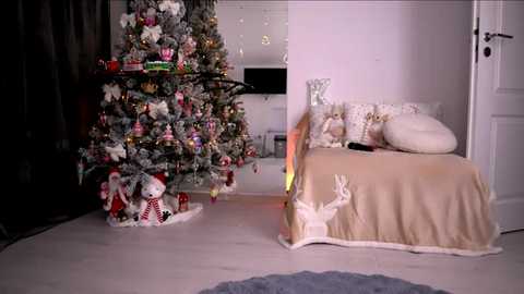 A festive video of a Christmas-themed bedroom with a decorated tree, a bed adorned with reindeer and Christmas ornaments, and a soft white carpet.