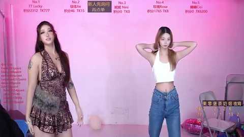 Video of two women in casual outfits: one in a patterned dress, the other in a crop top and jeans, standing against a pink backdrop with numbered labels.
