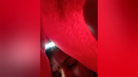 Close-up video of a human anus, viewed from above, with the surrounding red skin and hair visible. The image is cropped and tightly focused, with no background details visible.