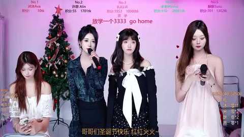 Video of four Asian women in casual dresses, singing into microphones, against a Christmas tree backdrop with Chinese text.