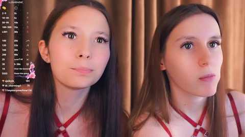 Video of a young woman with long dark hair, fair skin, and a slender build, wearing a red dress, against a brown curtain backdrop.