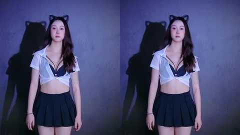 Video of an East Asian woman with long black hair, wearing a black cat ear headband, white cropped shirt, black bra, and a short black skirt, standing against a dark, textured wall.
