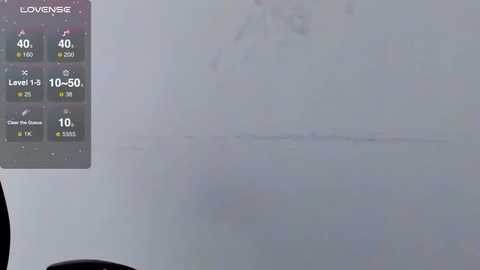 A video shows a smudged, fogged-up window with a smartphone screen displaying weather details, including temperature and humidity levels, in the upper left corner.