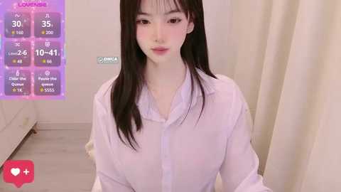 Video of a young Asian woman with long black hair, wearing a white button-up shirt, indoors, with a \"Love Live!\" digital profile overlay on the left.