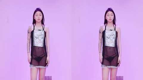 Video of an Asian woman with long black hair, wearing sheer black lingerie with floral lace, standing against a pink background, appearing as a mirrored image.