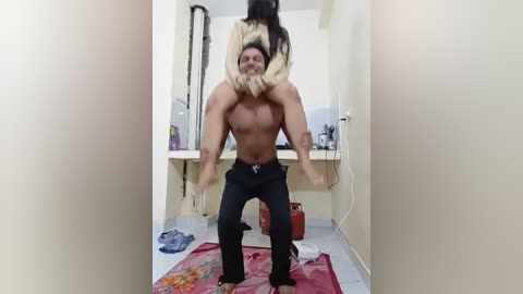 A video captures a muscular shirtless man, holding a woman upside down, in a narrow, cluttered hallway with beige walls and scattered items on the floor.