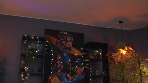 Video of a vibrant, dark room with a colorful mural, fairy lights, and a hanging lamp.