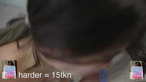 A blurred video of a person lying on a bed, with a text overlay stating \"harder = 15tkm.\" The image features a person's face and chest, suggesting a close-up, intimate scene.