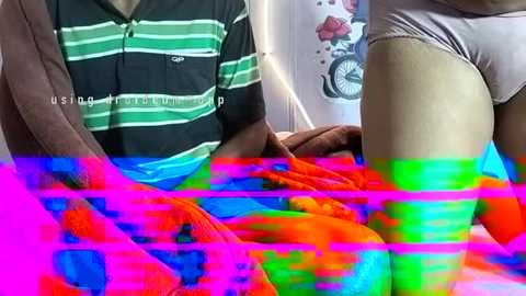 A video of a person in a green and white striped shirt and beige underwear sitting on a bed, overlaid with vibrant, colorful neon lines.