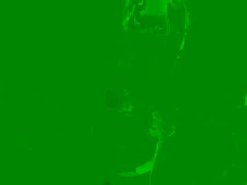 A green-hued video with a blurred, indistinct subject, possibly an aerial view of a cityscape or industrial area, lacking identifiable features or landmarks.