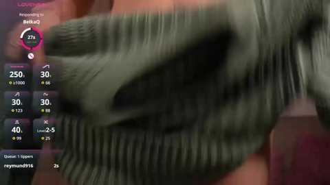 Video of a close-up, blurry greenish-gray snake-like creature with a textured, rough surface. The background is indistinct. Text overlay displays user comments and statistics.