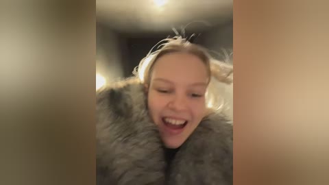 Video of a joyful blonde woman in a fur coat, with a blurred background, captured in a candid, dynamic moment.