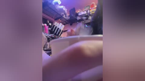 Video of a blurry, dimly-lit bar with a close-up of a white wine glass, showing a mix of red and blue lights.