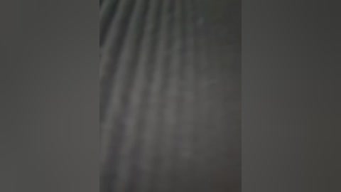 Media: A blurred, monochromatic video of a dark, textured surface with visible waves or ripples, likely depicting water or a liquid substance.