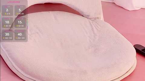 Video of a white, ribbed, cushioned chair with a pink background, displaying a \"Lounger\" app screen with 10, 15, 20, and 40-minute timer options.