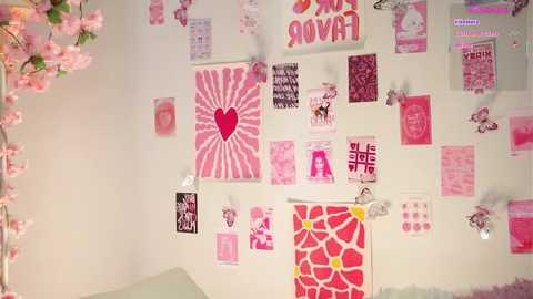 A video of a pink-themed wall covered in heart-shaped posters, ribbons, and flowers, with a large red heart at the center, creating a romantic and whimsical atmosphere.