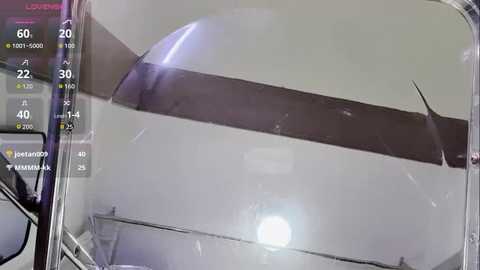 Video of a car windshield with a vertical crack, partially obstructing the view. The image includes a digital HUD overlay showing speed, distance, and location information.
