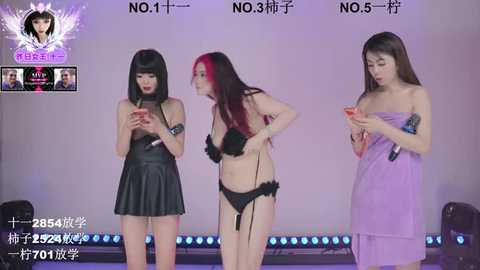 Video of three Asian women with fair skin, in revealing black leather and purple lingerie, holding smartphones, against a purple backdrop.