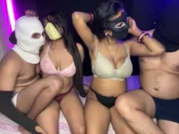 Media: Video of four people, two men and two women, wearing panda masks and lingerie, sitting on a bed, hands behind heads, in a dimly lit room with purple and pink lights.
