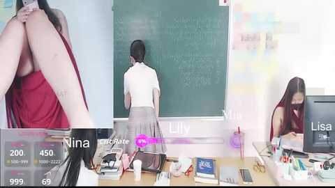 Media: A video of an Asian woman in a red top and gray skirt, facing a green chalkboard, surrounded by cluttered desk items.