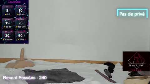 Video of a woman lying on a white floor, wearing a black dress, surrounded by a video game interface with stats, a game controller, and \"Francis Jex\" watermark.