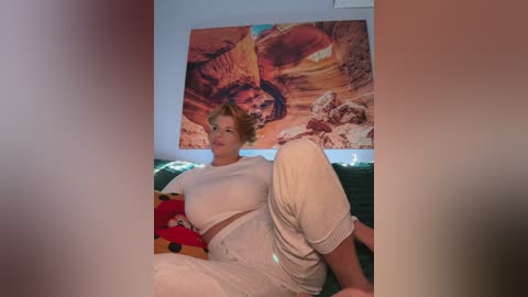 Video of a woman with blonde hair in white outfit, sitting on a couch, surrounded by stuffed animals, with a poster of \"Star Wars\" behind her.
