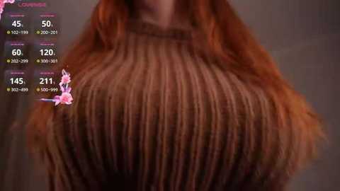 Video of a woman's chest in a brown, ribbed sweater, with a blurred background. Overlaying the image are virtual pink cherry blossoms and a digital health monitor with statistics.