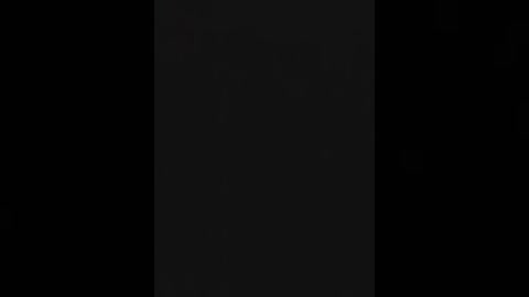 A video of a black vertical rectangle in a pitch-black background, suggesting a simple, minimalistic, and abstract composition.