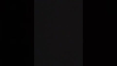 A video of a dark, vertical rectangular object against a black background, possibly a monolith or a vertical slab, with no discernible details, evoking mystery and minimalism.