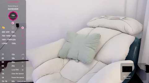 A video of a white leather recliner with a light green cushion, set in a minimalist room with a digital display on the left showing health data.