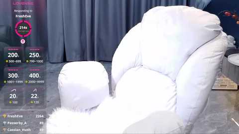 Video of a plush, white, overstuffed chair with a fluffy faux-fur throw, set against dark gray curtains. A digital screen overlay displays temperature and humidity levels, indicating 24\u00b0C and 50% humidity.