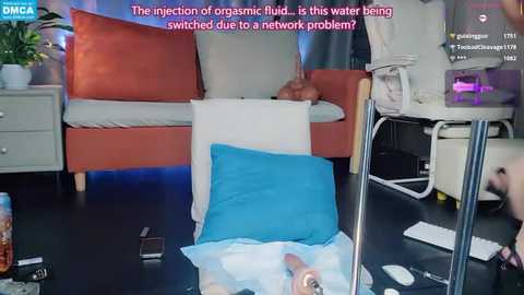 Media: Video of a messy room with a TV showing a news segment about a waterborne organic fluid infection, featuring a white man in a beige shirt.