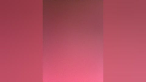 A video of a smooth, gradient wall painted in varying shades of pink, transitioning from light to dark, with no discernible objects or textures. The image is minimalistic, focusing solely on the color gradient.