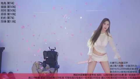 Video of a scantily clad East Asian woman in a white crop top and shorts, holding a pink dildo, amidst pink confetti, in a studio setting with Chinese text.