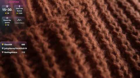 Media: Video of a close-up view of a brown, knitted fabric, showing detailed texture and stitches. Social media metrics (views, likes, comments) are overlaid in the upper left corner.