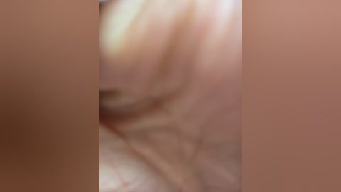 Media: Blurry video of a close-up human body, likely male, with visible skin and undefined features, positioned centrally in the frame.