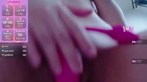 Media: A blurred, close-up photo of a person's hand on their pink, exposed genital area, with a smartphone screen displaying \"Lovense\" app settings and stats.