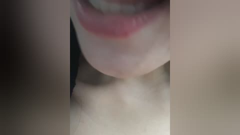 A close-up video of a woman's mouth, showing her lips and part of her nose, with a blurred background. Her lips are slightly parted, revealing a hint of teeth. The skin tone is fair, and the lighting is soft.