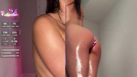 A video of a topless woman with wet, dark hair, showcasing her medium-sized breasts. She wears a pink bikini bottom. The background shows a bathroom with a blurred shower curtain.