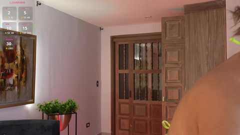 Media: A video of a cozy, well-lit living room with a wooden door, bookcase, potted plant, and a modern couch. The room exudes warmth and comfort.