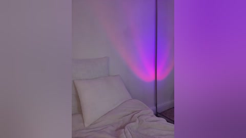 A minimalist bedroom scene with a white bed, a single pillow, and rumpled white sheets. A vibrant purple light casts a soft glow on the wall, creating an ethereal ambiance. The room has a clean, uncluttered aesthetic.