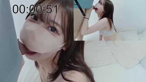 Media: Video of an Asian woman with long brown hair and fair skin, wearing a white mask and lingerie, gagged and kneeling on a white floor, taken from a first-person perspective.