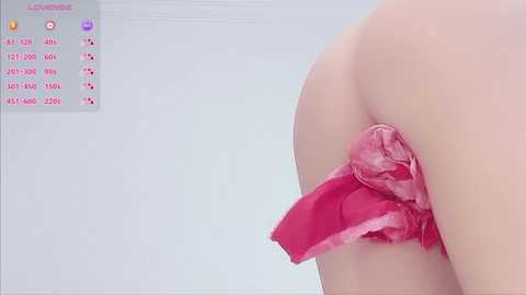Video of a pale-skinned woman's buttocks, partially covered by a torn, pink, lace-trimmed thong. A graph with red and blue bars is visible in the background.