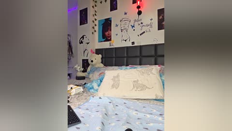 Video of a child's bedroom with a large teddy bear, a bed with a white pillow featuring a cat illustration, and a wall covered in stickers and posters, including a \"Star Wars\" poster.
