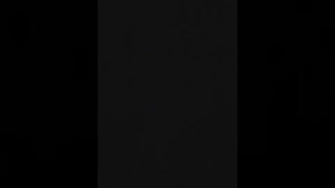 Media: A minimalist digital image featuring a tall, narrow, vertical black rectangle centered against a black background, creating a stark, monochromatic visual.